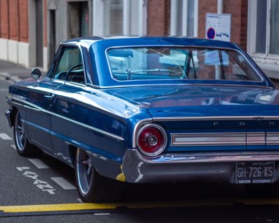 1964 Ford Galaxie 500 rear three-quarter view, deep blue paint, custom wheels, street photography