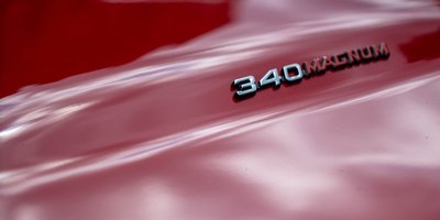 Macro automotive photography of a Dodge 340 Magnum badge on a classic American muscle car hood