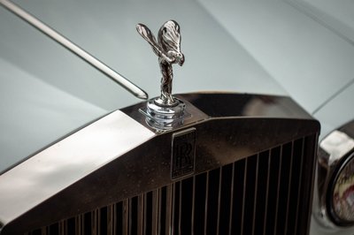 Luxury Rolls-Royce grille and Spirit of Ecstasy emblem captured in cinematic automotive detail photography