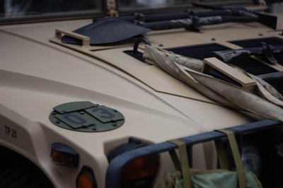 Military Humvee detail shot with rugged off-road styling and tactical vehicle photography aesthetic