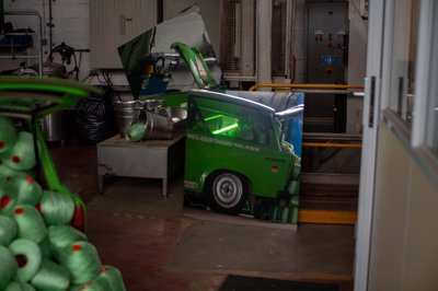 Custom green Trabant car display inside industrial workshop, ARF Industries motorsport event photography