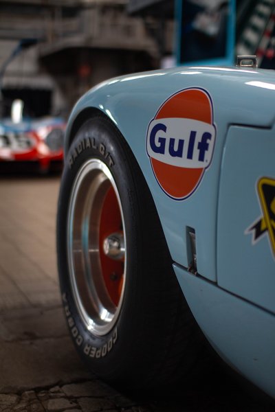 Gulf Oil sponsor sticker detail on Ford GT40 front wheel arch, Cooper Cobra tyre, Porsche 908 Esso in background