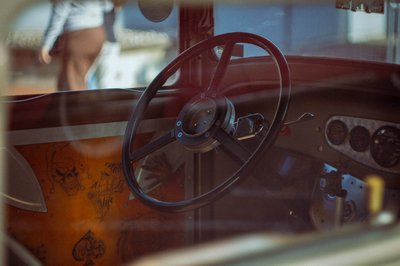 Vintage custom car interior with retro steering wheel and handcrafted dashboard details in cinematic lighting