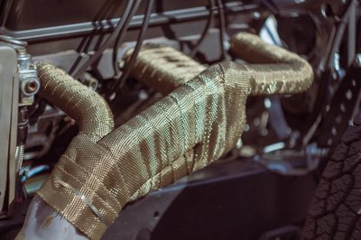 Heat-wrapped exhaust headers on a classic American V8 engine, motorsport preparation detail